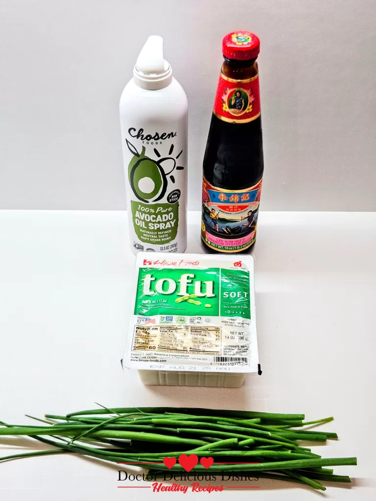 Ingredients for Tofu with Oyster Sauce including avocado oil spray, soft tofu, oyster sauce, and fresh green onions.