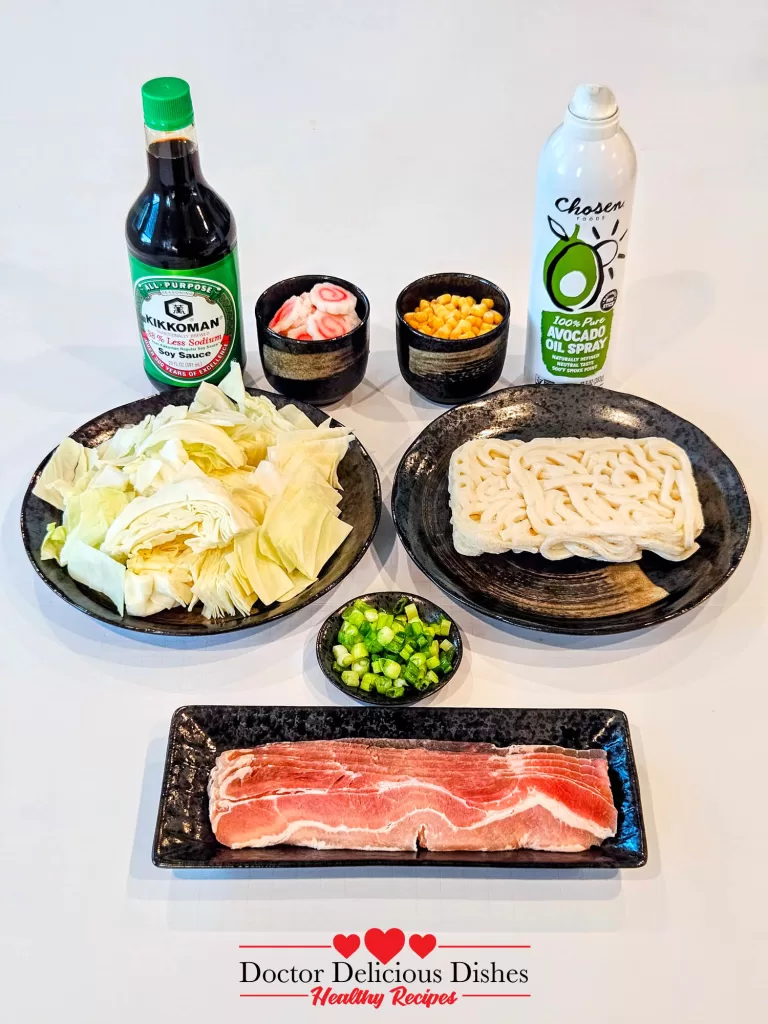 Ingredients for Easy Yaki Udon Recipe including pork slices, cabbage, corn, soy sauce, avocado oil spray, and udon noodles.