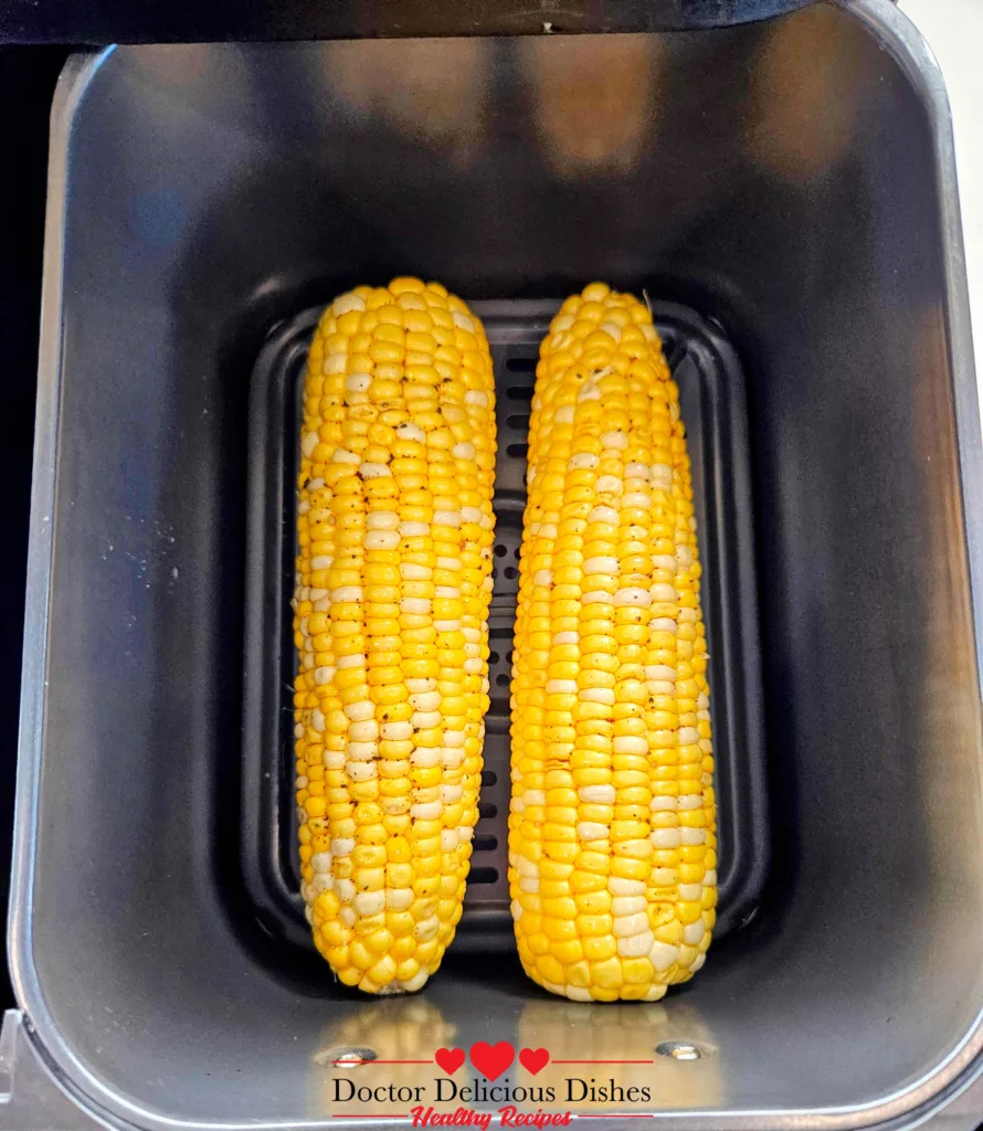 Air fryer corn on the cob placed inside the Ninja DZ550 basket