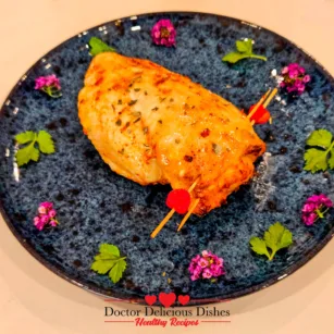 closeup of finished air fryer stuffed chicken breast plated with fresh garnish