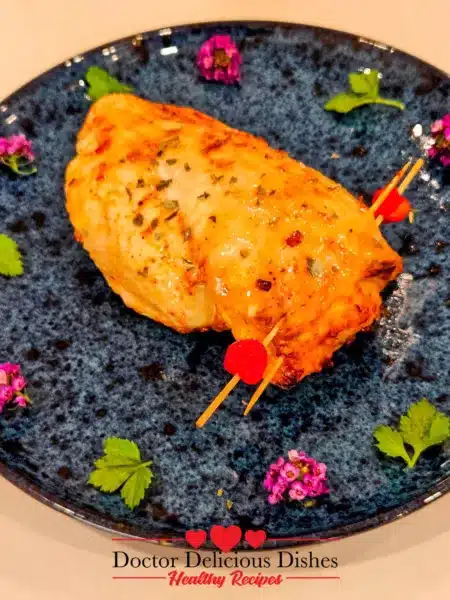 closeup of finished air fryer stuffed chicken breast plated with fresh garnish