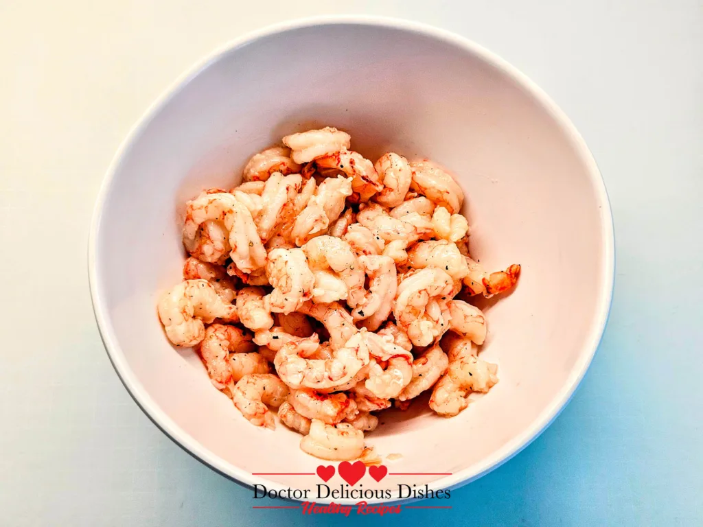 Garlic Butter Shrimp coated in oil, cornstarch, black pepper, and salt before air frying.