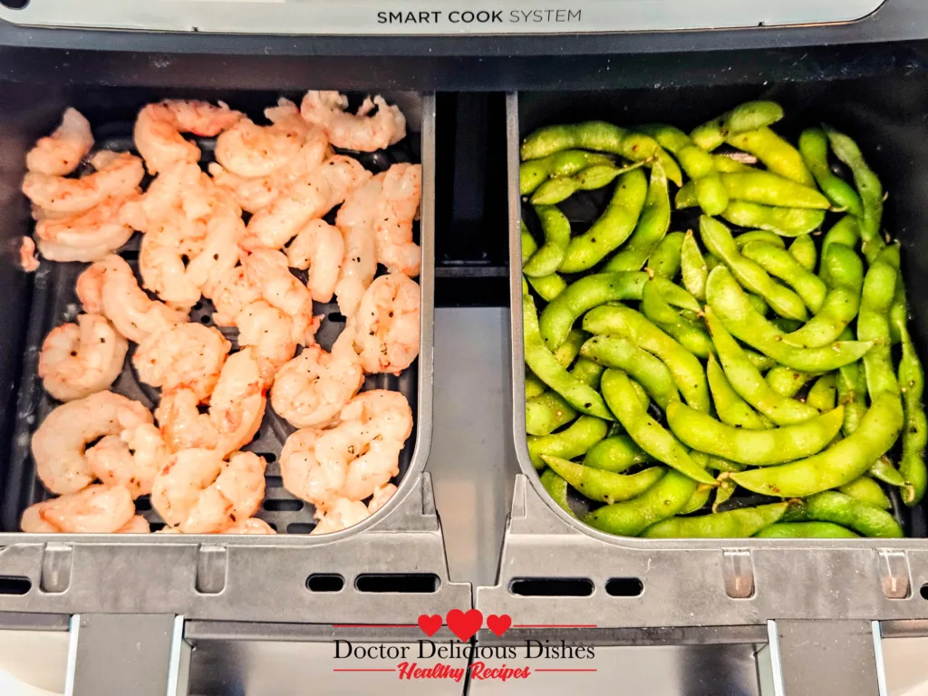 Japanese garlic soy Air Fryer Edamame cooking in one basket with shrimp in the other