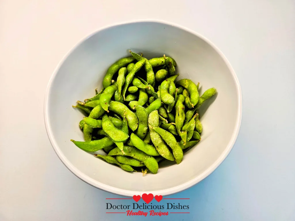 Seasoned Japanese garlic soy edamame tossed and ready for the air fryer