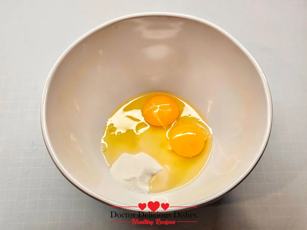 Eggs, sugar, and milk in a mixing bowl for Honey Castella Cake (air fryer castella recipe).