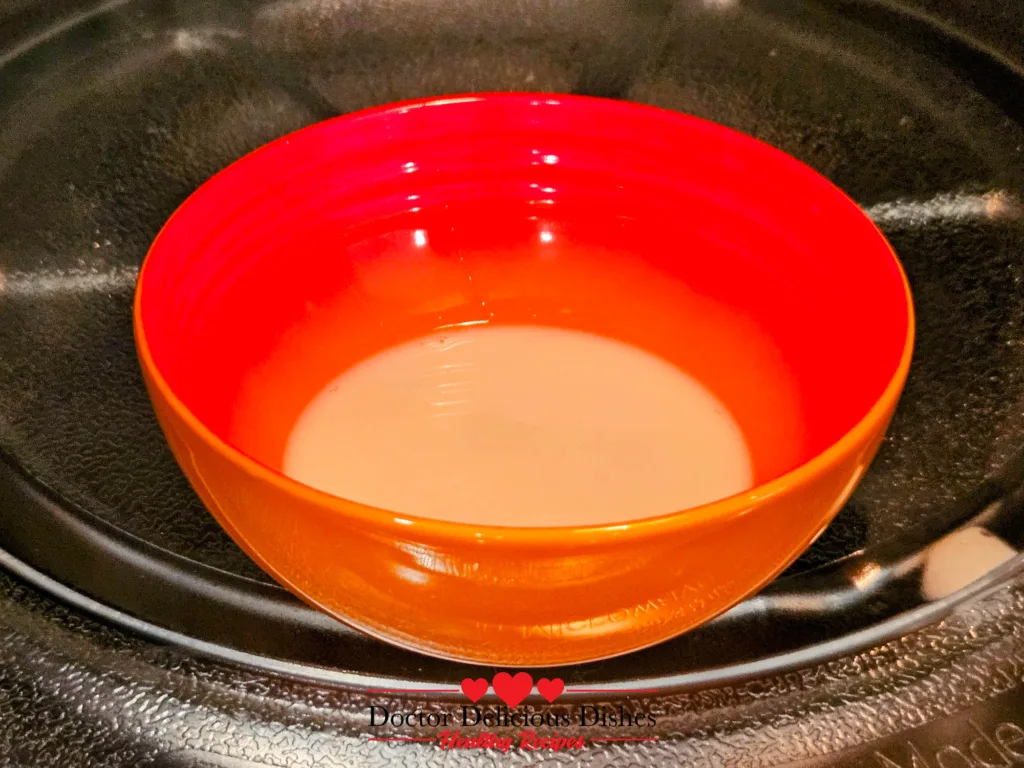 Warm milk and honey mixture heated in microwave for Honey Castella Cake
