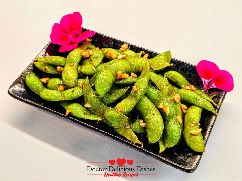 Plated Japanese-style garlic soy Air Fryer Edamame topped with fresh garlic