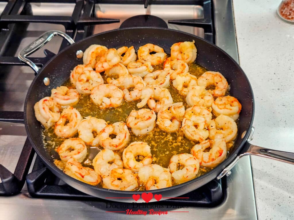 Cooked shrimp in olive oil, seasoned and ready to combine with almond pesto and large shell pasta.