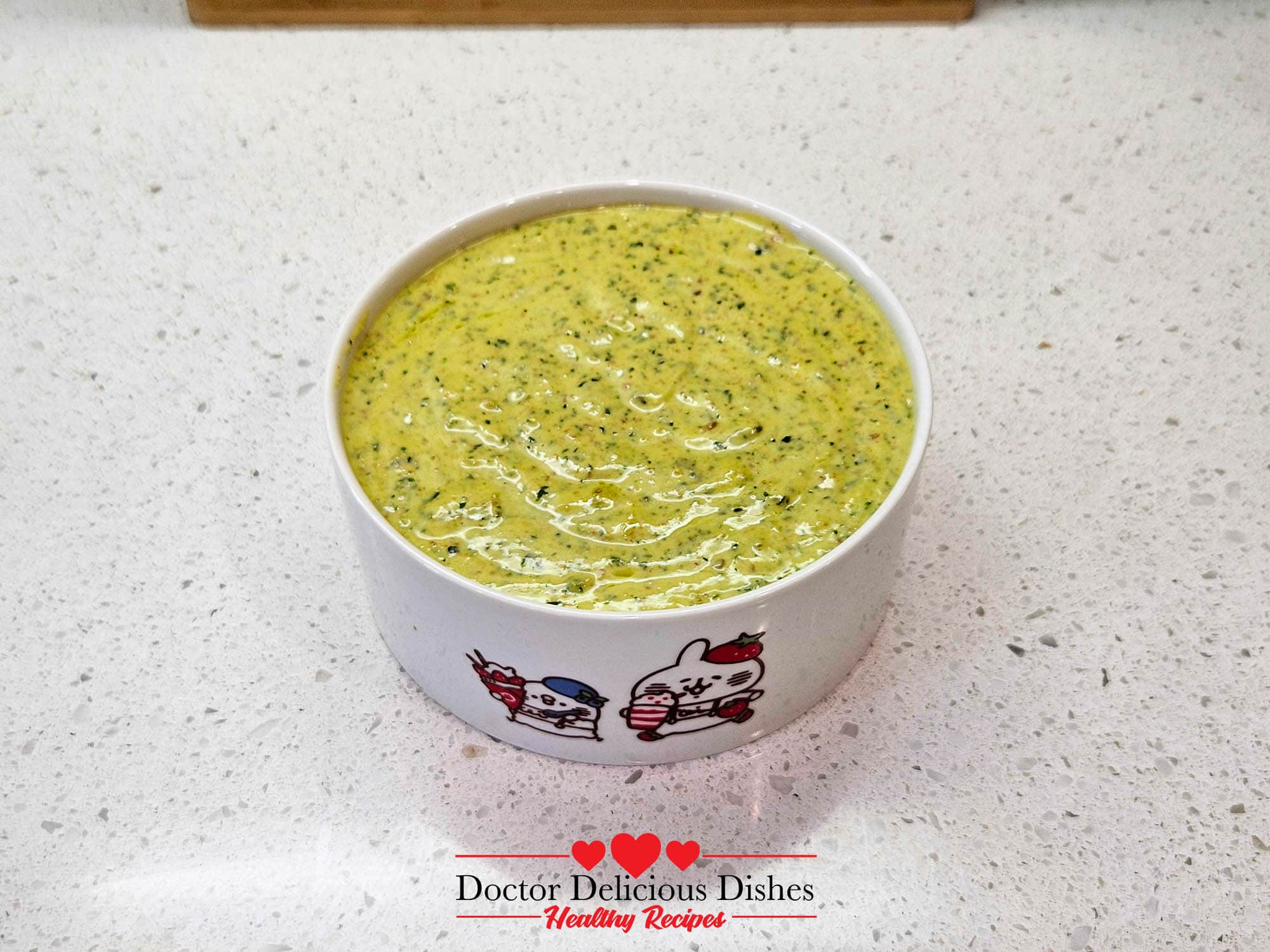 Homemade almond pesto in a small bowl, ready to mix with large shell pasta and shrimp.