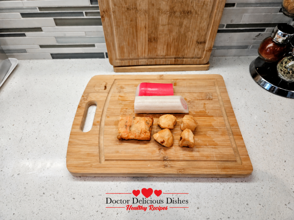 Assorted Japanese fish cakes including pink and white kamaboko and narutomaki for cold soba noodles